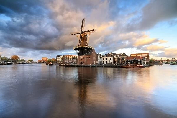Pink clouds at sunset on the Windmill De Adriaan reflected in the River Spaarne, Haarlem