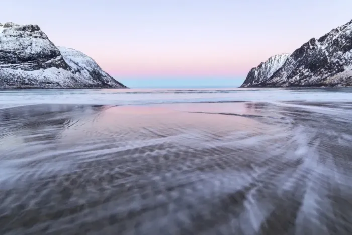 Framed Print : The pink light of sunrise over the waves of frozen sea surrounded by snowy peaks Framed Print : The pink light of sunrise over the waves of frozen sea surrounded by snowy peaks