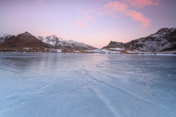 Framed Print : Pink lights of dawn on the snowy peaks around the frozen surface of Andossi Lake Framed Print : Pink lights of dawn on the snowy peaks around the frozen surface of Andossi Lake