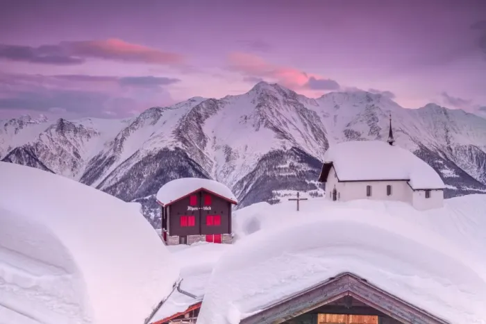 Framed Print : Pink sky at sunset frames the snowy mountain huts and church, Bettmeralp, district of Raron Framed Print : Pink sky at sunset frames the snowy mountain huts and church, Bettmeralp, district of Raron