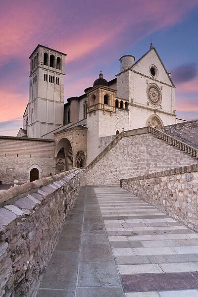 Pink sunrise over the Papal Basilica of Saint Francis in Assisi