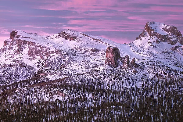 Pink sunrise on Five Towers (Cinque Torri) mountains in winter with snow, Dolomites
