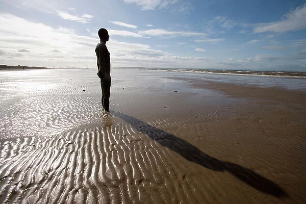 Another Place sculpture by Antony Gormley on the beach at Crosby, Liverpool