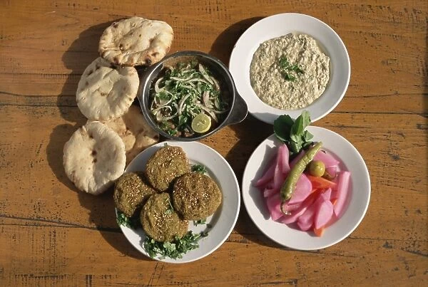 Plates of traditional food, falafel, babaghanoush and shawarma, with flat bread