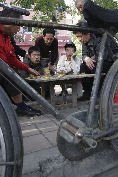 Playing Xiangqi, Chinese Chess, on the streets of Beijing, China, Asia