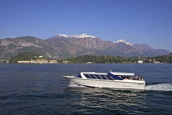 Pleasure boat crossing Lake Como from Bellagio in spring sunshine, Lombardy, Italian Lakes, Italy, Europe