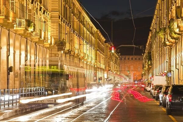 Via Po avenue lit up at night by passing traffic, Turin, Piedmont, Italy, Europe
