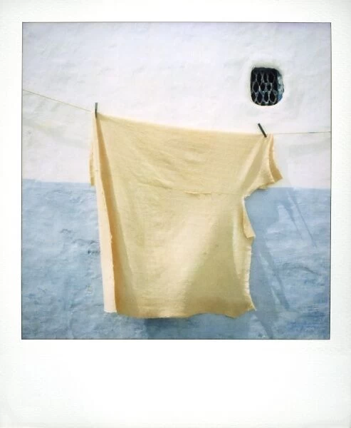 Polaroid image of blanket drying in the sun against