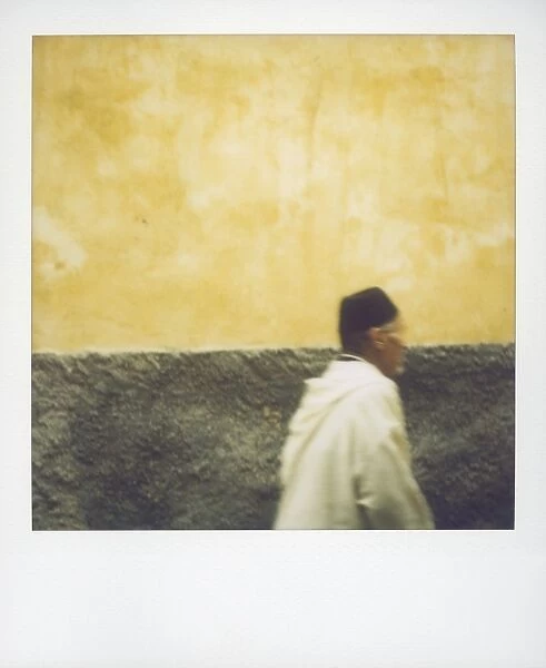 Polaroid image of man walking along street in the Medina