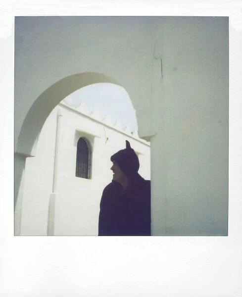 Polaroid image of man wearing traditional woolen djellaba