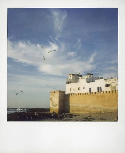 Polaroid image of old ramparts and whitewashed building