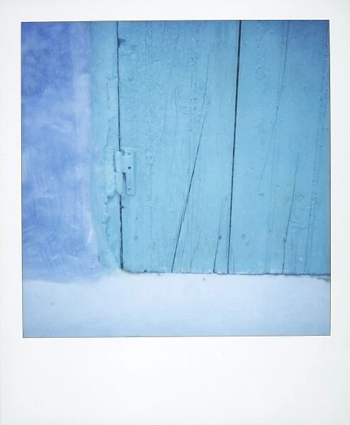 Polaroid of detail of a traditional painted blue door