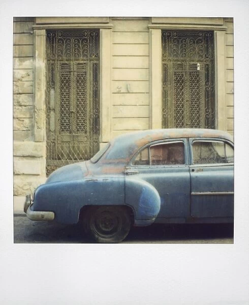 Polaroid of old blue American car covered in dust, Havana, Cuba, West Indies