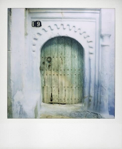 Polaroid of old door and whitewashed wall