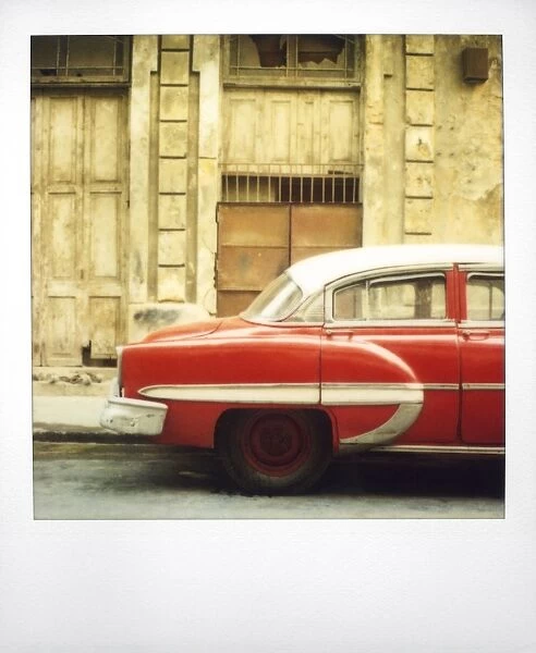 Polaroid of the profile of red classic American car, Havana, Cuba, West Indies