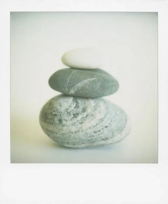 Framed Print : Polaroid of three sea-worn pebbles piled up against a white background Framed Print : Polaroid of three sea-worn pebbles piled up against a white background