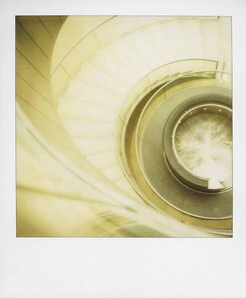 Polaroid of view looking down on spiral staircase in The Louvre museum
