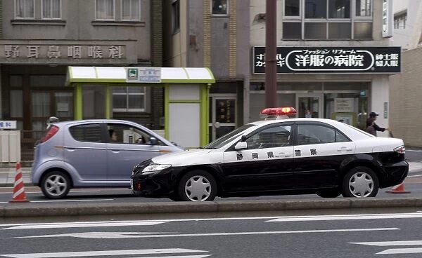 A police car from Shizuoka Prefecture speeding past, Tokyo, Japan, Asia