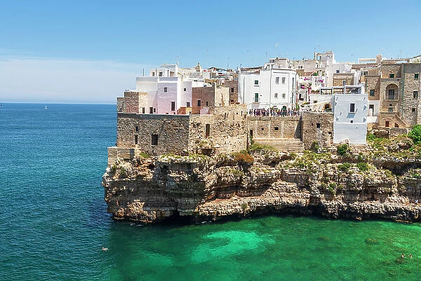 Polignano a mare, the medieval and white sea town facing the turquoise water of the Adriatic Sea, day time, Bari, Apulia, Mediterranean Sea, Italy, Europe
