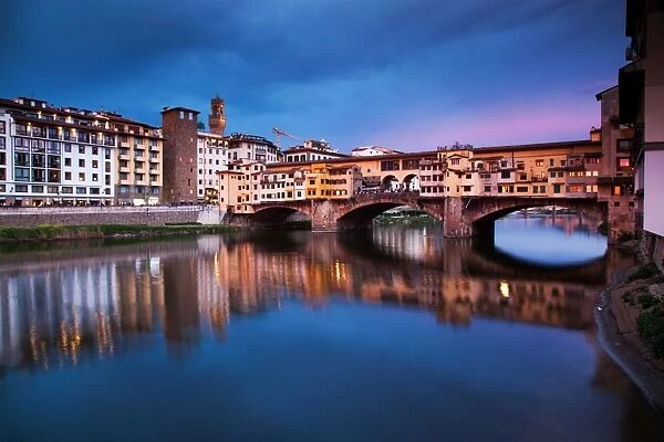 Ponte Vecchio at night reflected in the River Arno, Florence, UNESCO World Heritage Site