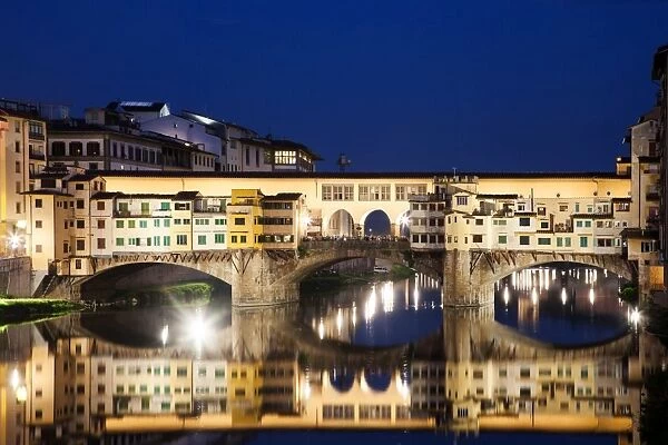 Ponte Vecchio at night reflecting in River Arno, Florence, UNESCO World Heritage Site