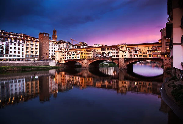 Ponte Vecchio at sunset reflecting in River Arno, Florence, UNESCO World Heritage Site