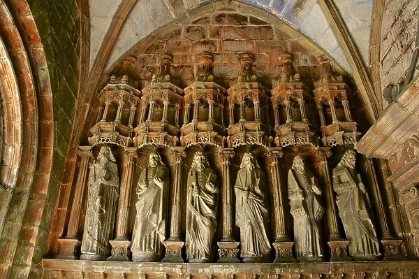 Porch entrance detail with statues of the Apostles, church dating from the 16th and 17th centuries, Guimiliau parish enclosure, Finistere, Brittany, France, Europe