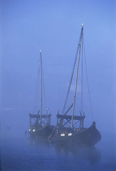 Two port wine barges in the mist on the River Douro in Oporto (Porto)