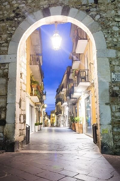 Porta Catania, one of the entrances to Corso Umberto, the main street in Taormina at night, Sicily, Italy, Europe