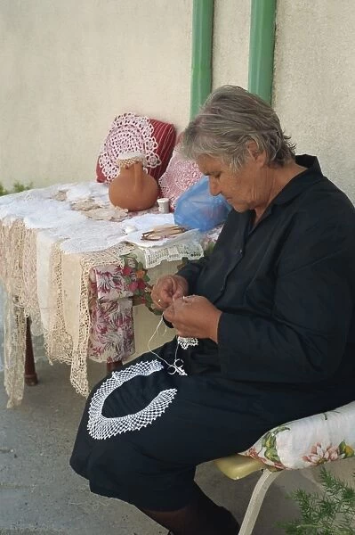Portrait of an elderly village woman dressed in traditional black, making lace in the Troodos Mountains, Ommados, south of the island, Cyprus