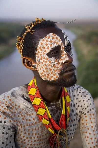 Portrait of a Karo tribesman with facial decoration in chalk imitating the spotted plumage of the guinea fowl, Lower Omo Valley