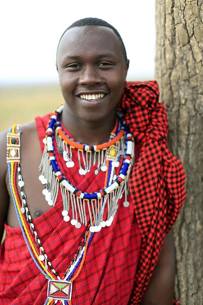 Portrait of a Masai man wearing colorful traditional clothes, Masai Mara Game Reserve