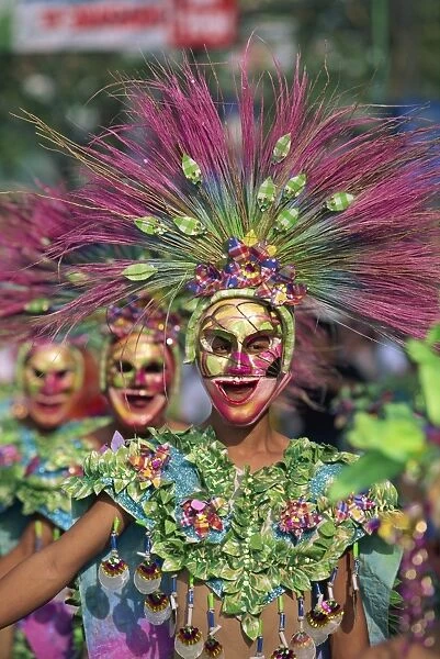 Portrait of a masked dancer in colourful costume at