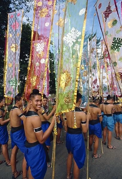 Portrait of a smiling man in a parade of colourful