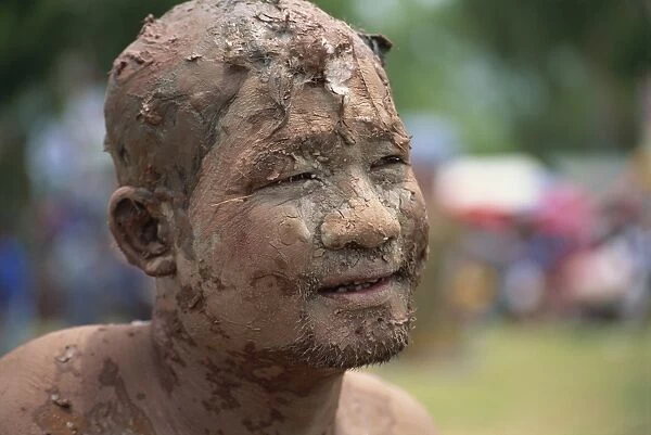Portrait of a Worship man with a muddy face during