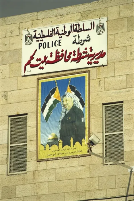 Framed Print : Poster showing Yasser Arafat on the wall of a Palestinian Police Station in Bethlehem Framed Print : Poster showing Yasser Arafat on the wall of a Palestinian Police Station in Bethlehem