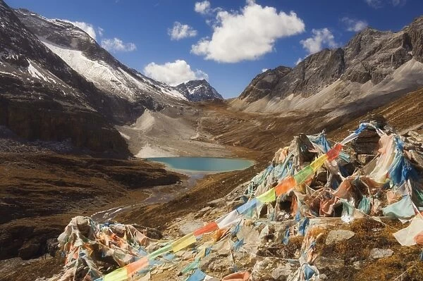 Prayer flags and Erongcuo Lake, Yading Nature Reserve, Sichuan Province, China, Asia
