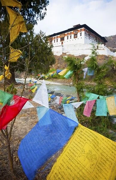 Prayer flags and Rinpung Dzong, Paro District, Bhutan, Asia