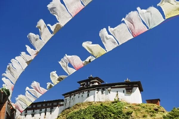 Prayer flags below Wangdue Phodrang Dzong, founded by the Zhabdrung in 1638, Bhutan, Asia