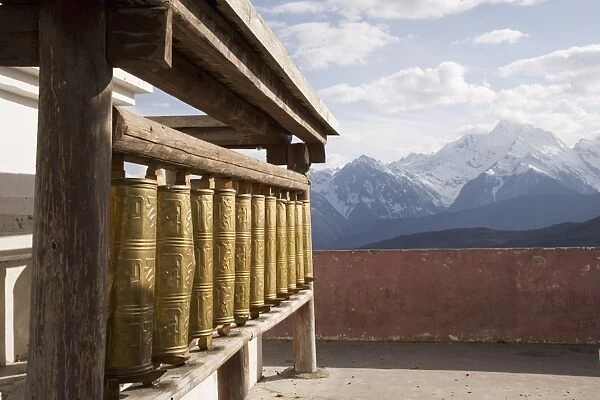 Prayer wheels with Meili Snow Mountain peak in the background, en route to Deqin