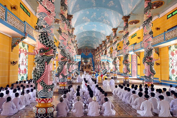 Praying devout men and women, ceremonial midday prayer, Cao Dai Holy See Temple, Tay Ninh