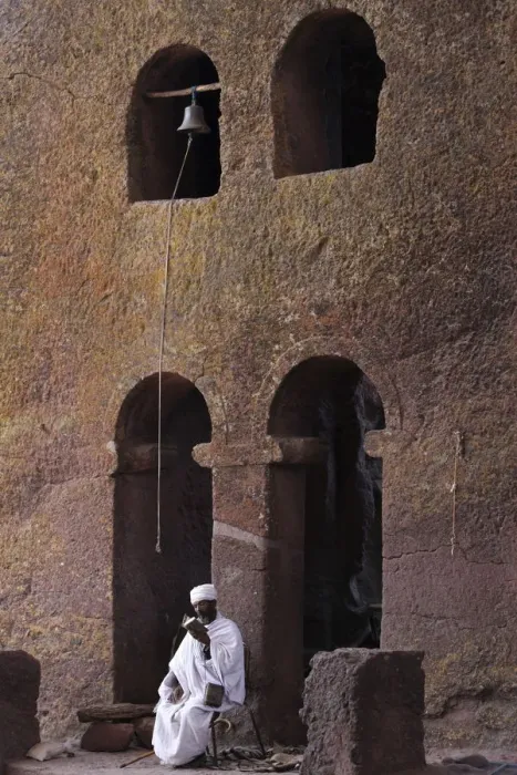 Framed Print : Priest reading a Bible in Bet Maryam church courtyard, UNESCO World Heritage Site Framed Print : Priest reading a Bible in Bet Maryam church courtyard, UNESCO World Heritage Site
