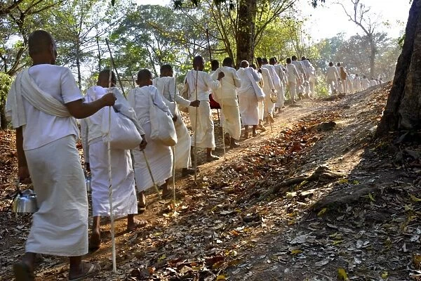 A procession of Buddhist nuns make their way through the temples of Angkor