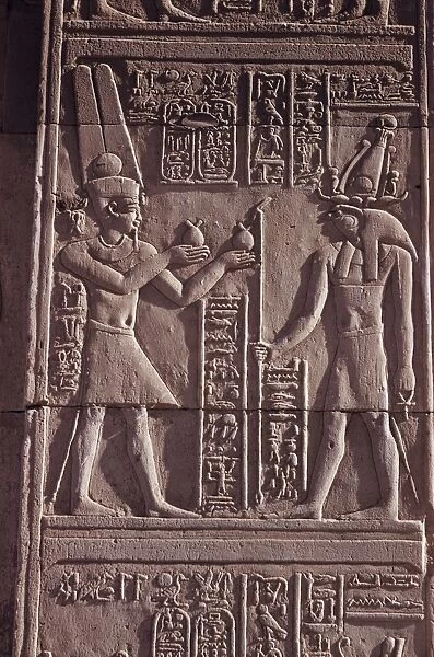Ptolemaic low relief of the hawk-headed god Horus presented with offerings