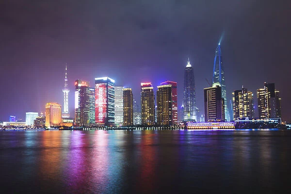 Pudong skyline at night across the Huangpu River, Shanghai, China, Asia