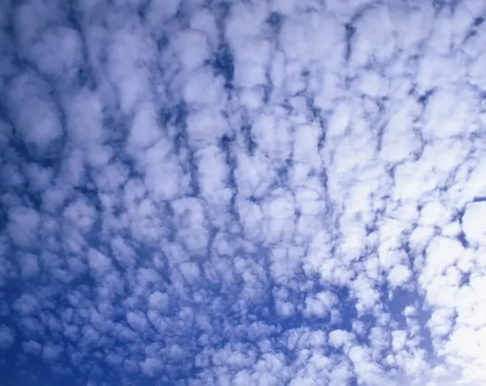 Framed Print : Puffy white clouds cover a blue sky