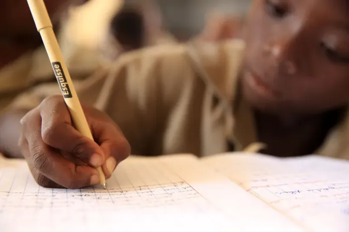 Framed Print : Pupil taking notes in French class in African primary school, Lome, Togo, West Africa Framed Print : Pupil taking notes in French class in African primary school, Lome, Togo, West Africa