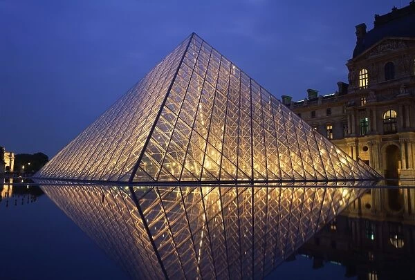 The Pyramide and Palais du Louvre, Musee du Louvre, illuminated at dusk
