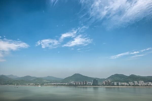 Qiantang River, hills and high rises of Hangzhou, Zhejiang, China, Asia