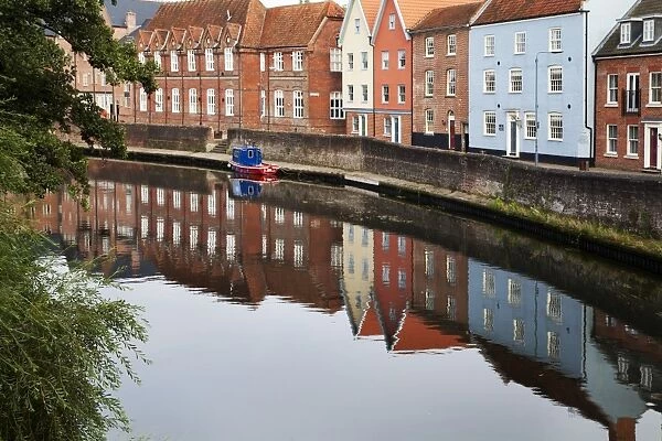 Quayside buildings reflected in the River Wensum, Norwich, Norfolk, England, United Kingdom, Europe